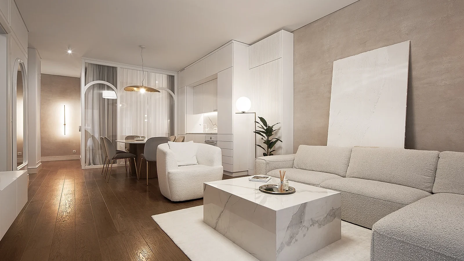KMR living room with a curved sofa, stone coffee table and warm indirect lighting
