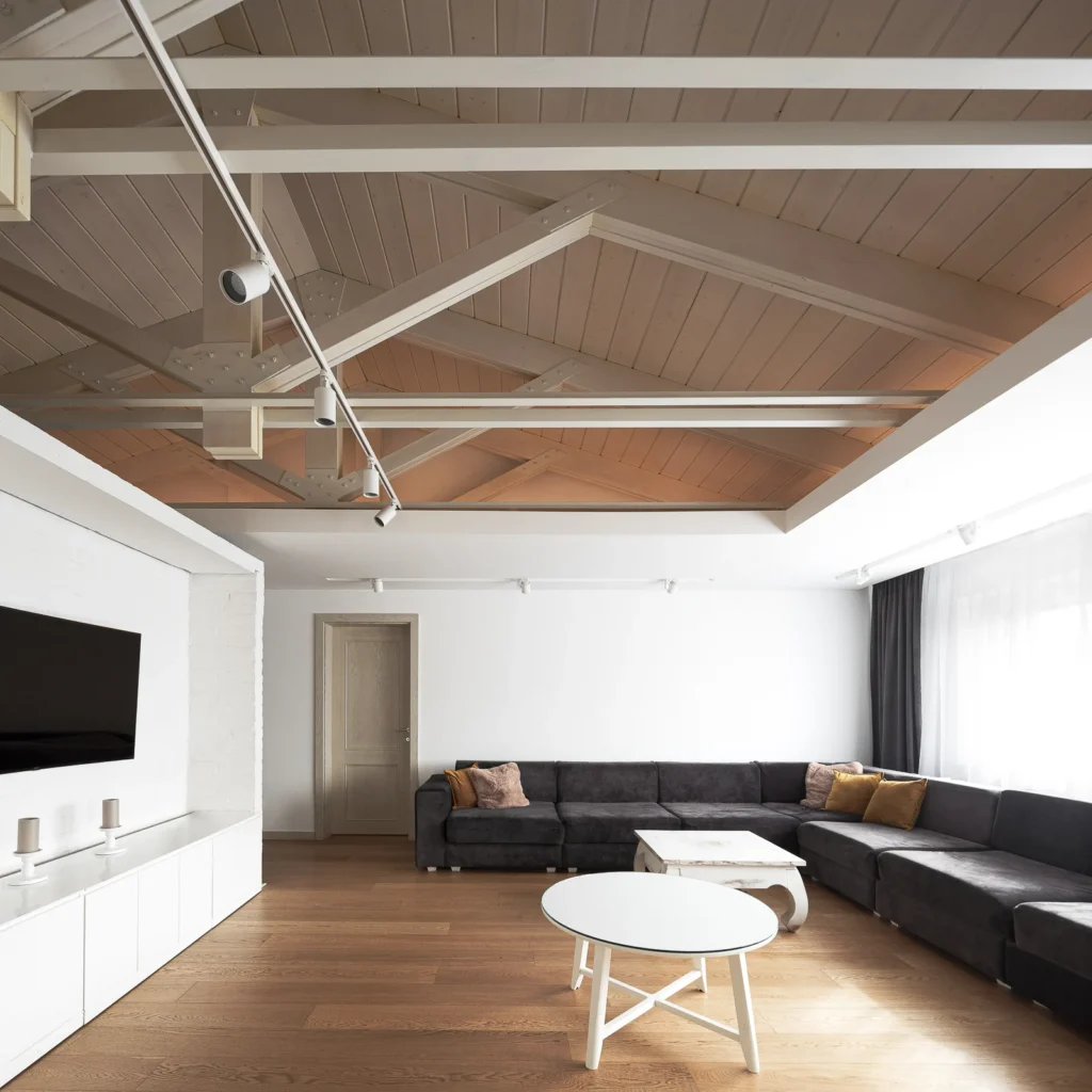 S27 living area with exposed timber roof structure and integrated linear lighting