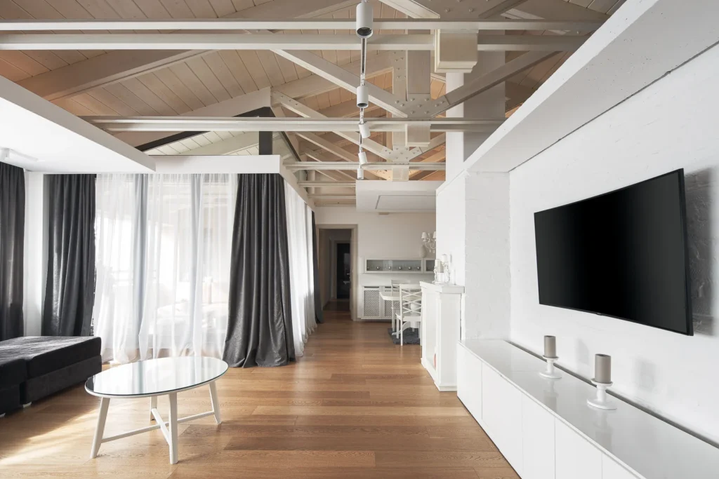 White media wall and floating ceiling details in the S27 Apartment living room