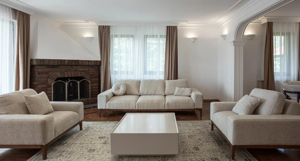 BP77 living room with neutral seating, ornamental parquet and the original brick fireplace