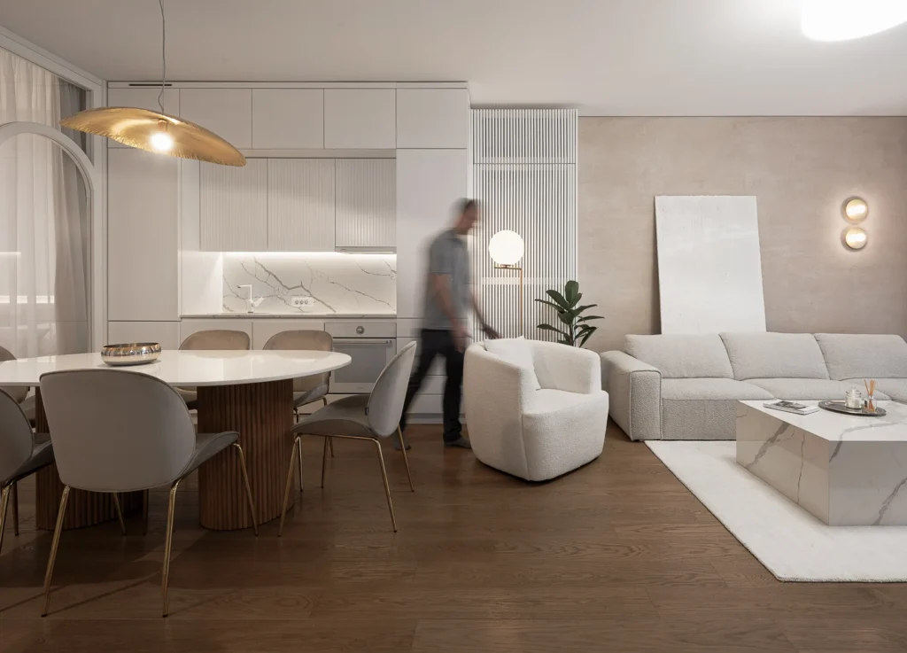 KMR Apartment open living and dining area with soft neutral furnishings and layered curtains