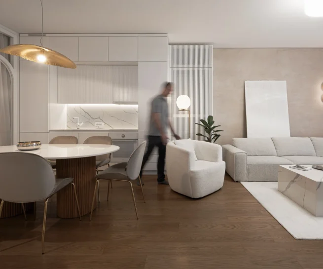 KMR Apartment open living and dining area with soft neutral furnishings and layered curtains