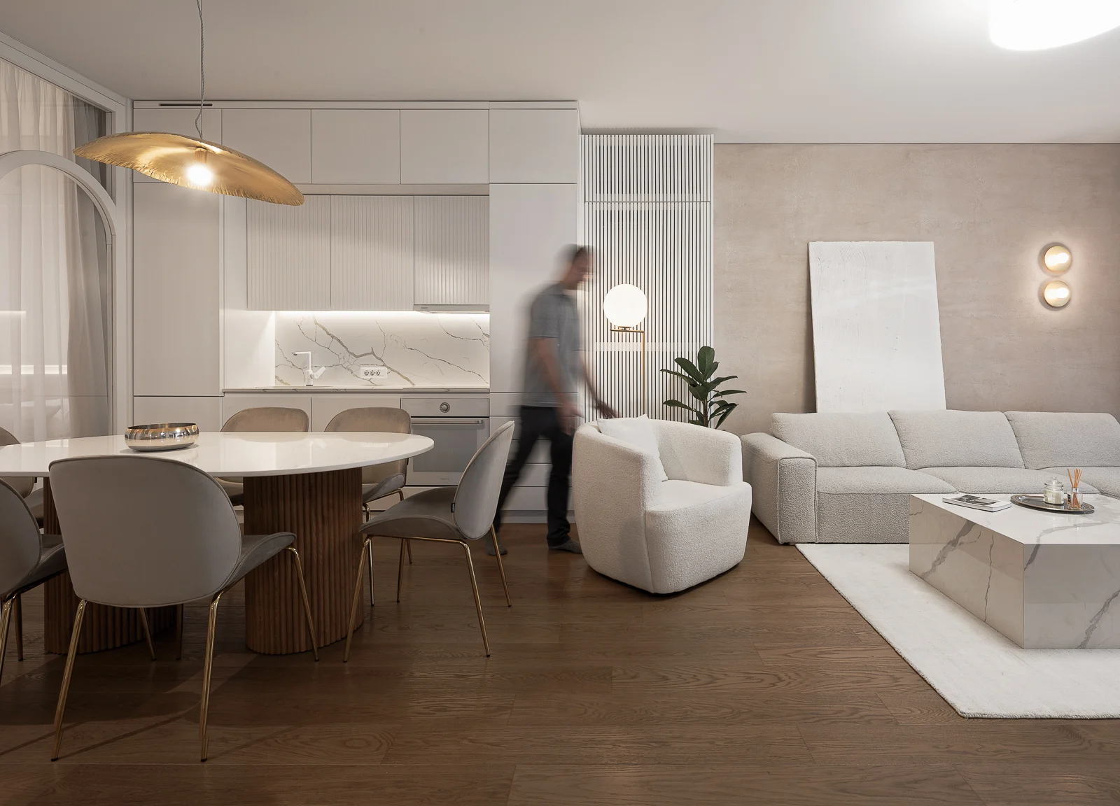 KMR Apartment open living and dining area with soft neutral furnishings and layered curtains