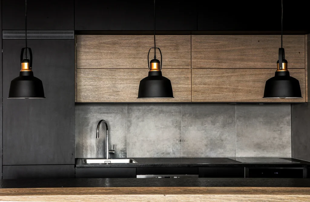 Matte black A75 Apartment kitchen with a concrete-look backsplash and pendant lights