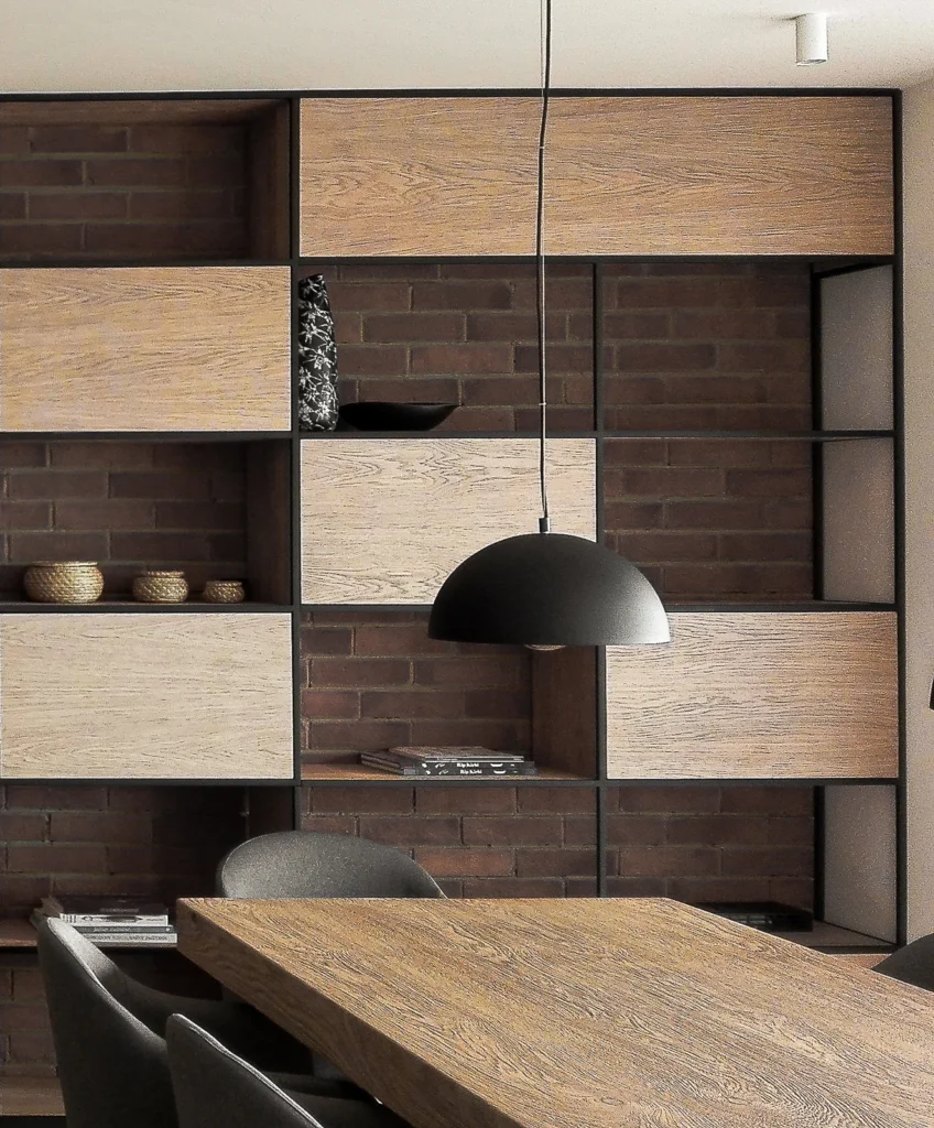 Custom timber and black metal shelving dividing the A75 dining and living areas
