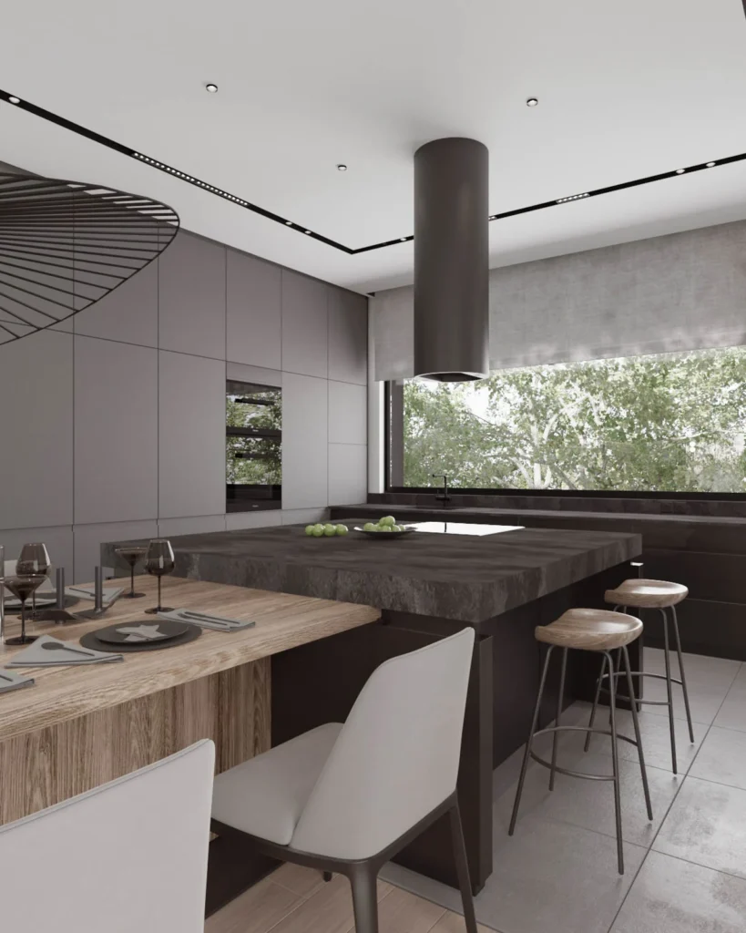 Wood dining table and dark kitchen island beneath sculptural lighting in Kovačevac House