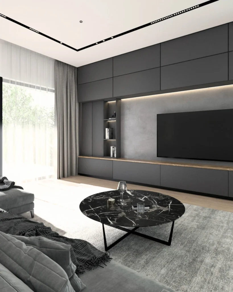 Kovačevac House living room with a sculptural black coffee table and illuminated media wall