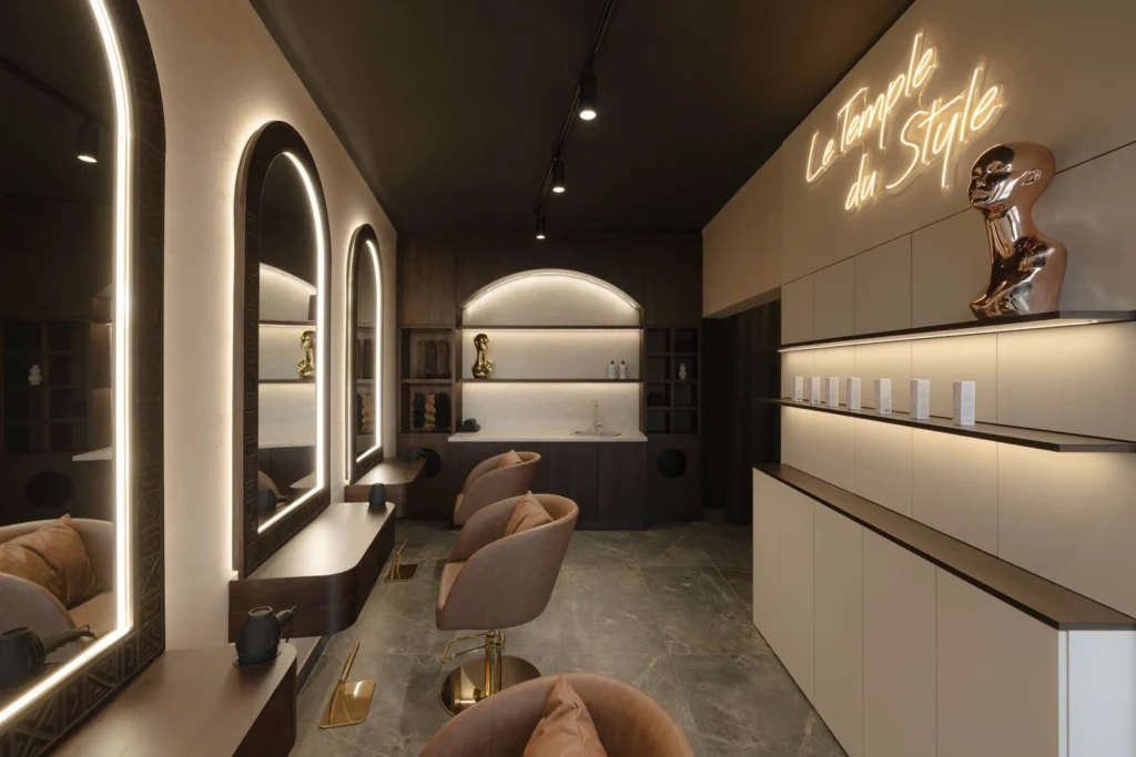 Women's styling area with illuminated mirrors, custom cabinetry and French neon lettering