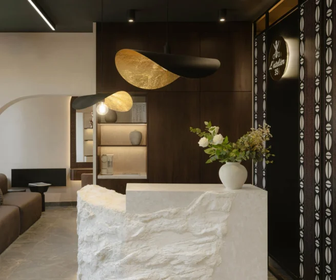 L'Atelier 35 waiting lounge, textured reception desk and curved patterned screen