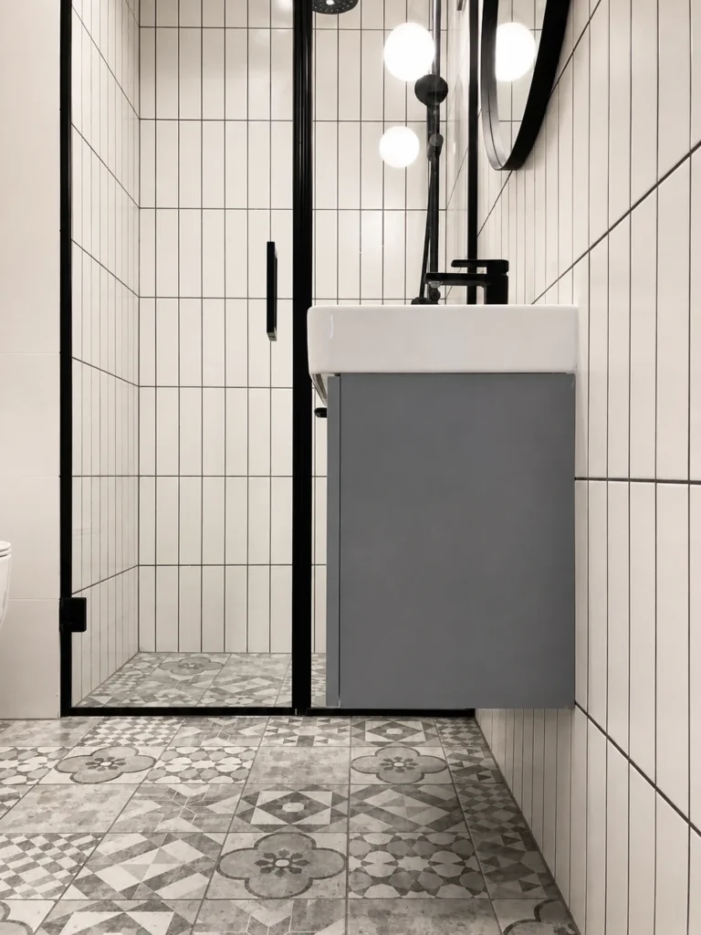 MC33 Apartment compact bathroom with grey vanity, white grid tiles and patterned floor