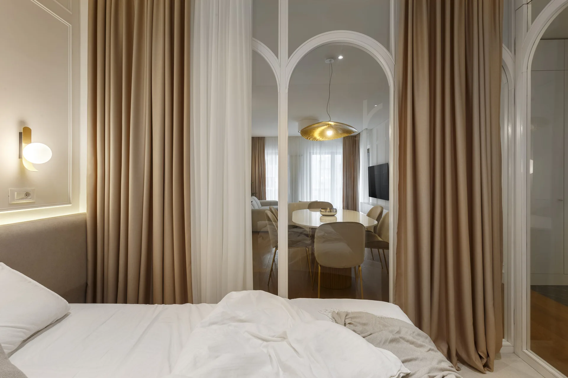 View from the KMR glass-enclosed bedroom toward the dining area through arched partitions