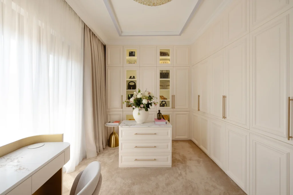 MBS Master Suite dressing room with ivory panelled wardrobes, illuminated niches and central dresser